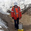 access road & culvert installation construction: workers dig to install large pipes