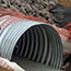 access road & culvert installation construction: orange fence placed around functioning pipe